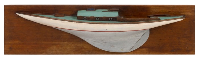 MOUNTED HALF HULL MODEL OF A SAILBOAT America, 20th Century Backboard 7" x 26".