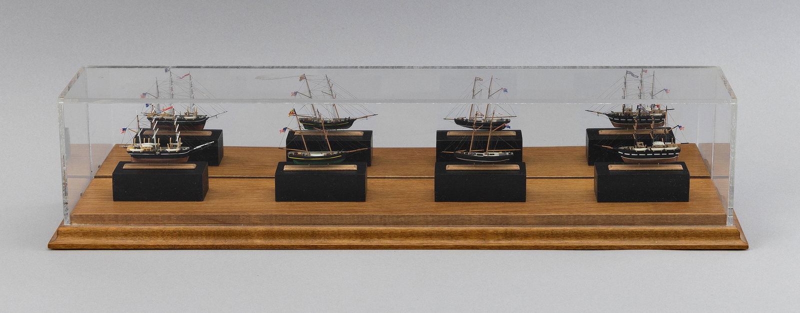 FOUR MINIATURE SHIP MODELS BY ROBERT SHEA, HOUSED IN A SINGLE CASE: FOUR MINIATURE SHIP MODELS BY ROBERT SHEA, HOUSED IN A SINGLE CASEMarked on bottom of case: Shea Miniatures, Centerville, MA. (Robert Shea)Case dimensions: height 4", length 17.5", depth 3.75".