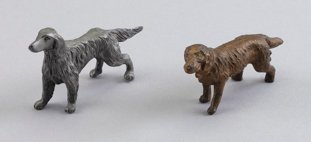 TWO CONTINENTAL PAINTED METAL SETTERS Early 20th Century Heights approx. 2". Lengths approx. 3".