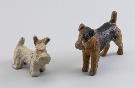 TWO CONTINENTAL COLD-PAINTED BRONZE TERRIERS Early 20th Century Heights 2" and 3".