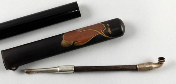 JAPANESE BLACK, RED AND GOLD LACQUER PIPE CASE WITH PIPE Late Meiji Period Pipe length 8". Case