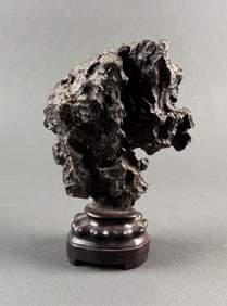 CHINESE LIMESTONE SCHOLAR'S STONE 19th Century Height 6". Length 6". With a wooden stand.