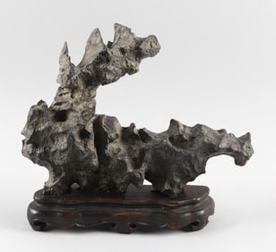 CHINESE GRAY/BLACK LINGBI SCHOLAR'S STONE Height 9.5". Length 12". With a fitted wooden stand.