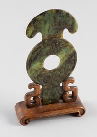 CHINESE ARCHAIC-STYLE CARVED MOTTLED GREEN JADE KUEI PI Length 7". With a fitted wooded stand.