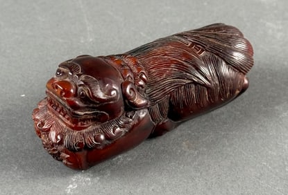 CHINESE CARVED DARK AMBER RECLINING FU LION 19th Century Length 3".