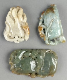 THREE CHINESE CARVED CELADON JADE PENDANTS Lengths from 1.75" to 2.5".