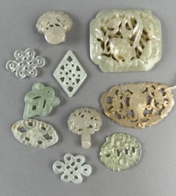 NINE CHINESE CELADON JADE AND HARDSTONE OPENWORK CARVINGS Lengths from 1" to 2.5".
