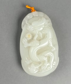 CHINESE CARVED WHITE JADE PEBBLE-FORM PENDANT Length 2.5".