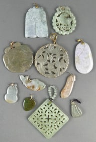 ELEVEN PENDANTS, MOSTLY CELADON JADE Lengths from 1" to 2".