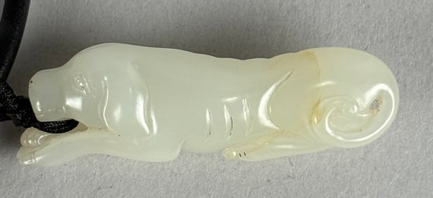 CHINESE CARVED WHITE JADE RECUMBENT DOG PENDANT Length 2".