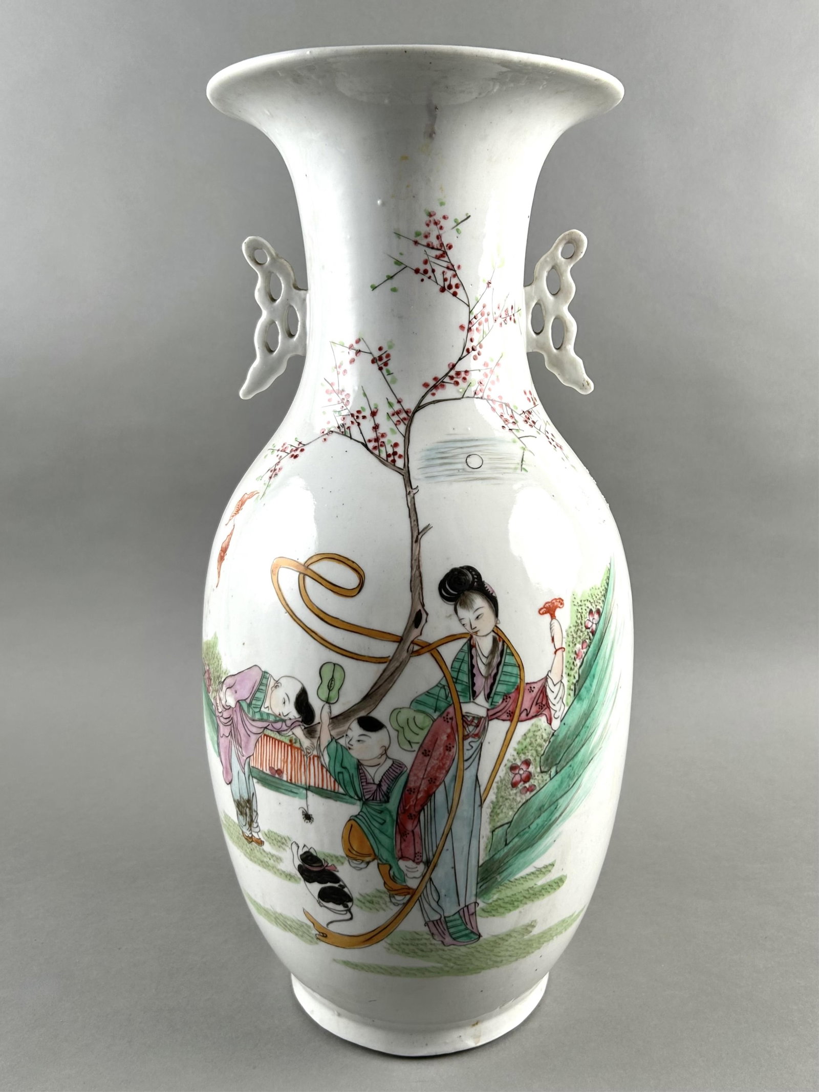 CHINESE FAMILLE ROSE PORCELAIN BALUSTER VASE Late 19th Century Height 18.5".: CHINESE FAMILLE ROSE PORCELAIN BALUSTER VASE Late 19th Century Decoration of figures in a spring landscape. Ruyi-form handles on neck. Height 18.5".