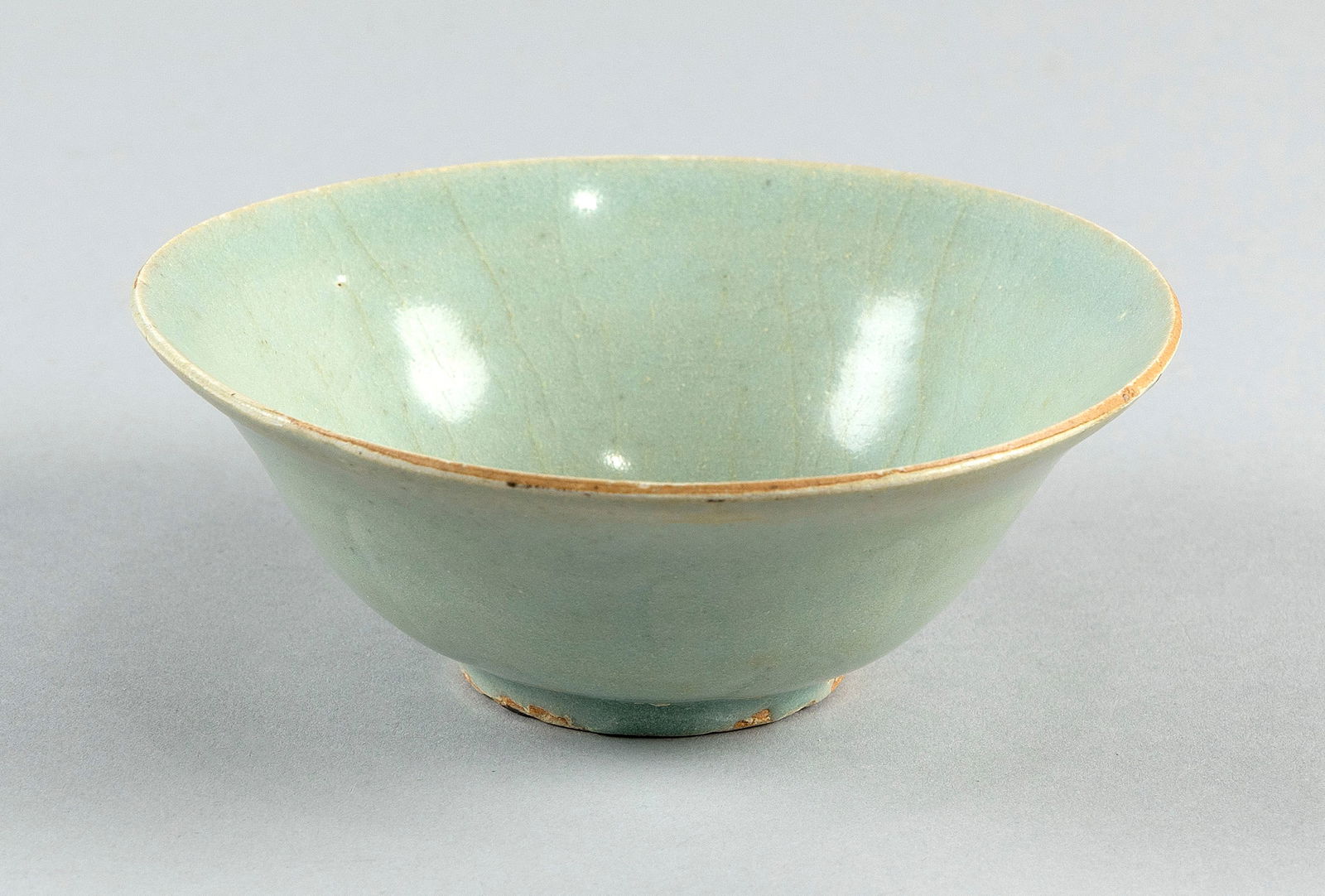 CHINESE LONGQUAN CELADON PORCELAIN BOWL Late Song Dynasty Height 3". Diameter 5.75".: CHINESE LONGQUAN CELADON PORCELAIN BOWLLate Song DynastyFaint blue tint to glaze. Exterior with incised lotus decoration. Label for Australian Antique Dealers Association.Height 3". Diameter 5.75". Pr