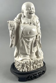 CHINESE BLANC DE CHINE PORCELAIN FIGURE OF BUDDHA Early 20th Century Height 12.5". Length 6". With a