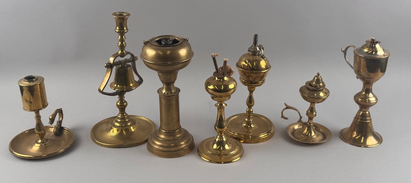 SEVEN BRASS FLUID AND WHALE OIL LAMPS 19th Century Heights from 6.5" to 11.5".: SEVEN BRASS FLUID AND WHALE OIL LAMPS 19th Century Varied forms. Heights from 6.5" to 11.5".