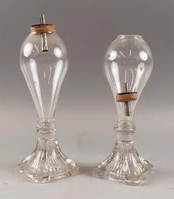 PAIR OF PRESSED AND FREEBLOWN CLEAR GLASS LAMPS First Half of the 19th Century Heights 7".