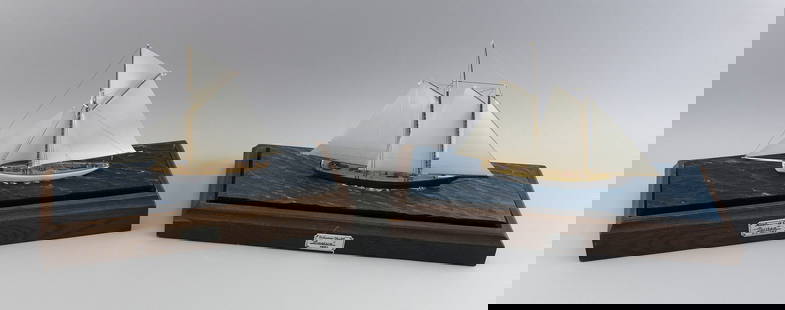 PAIR OF CASED MODELS OF AMERICA'S CUP YACHTS 20th Century Case heights 13". Lengths 17". Widths 7".: PAIR OF CASED MODELS OF AMERICA'S CUP YACHTS20th CenturyThe America and the Puritan. Set in resin seas. Brass and glass cases with wooden bases.Case heights 13". Lengths 17". Widths 7".