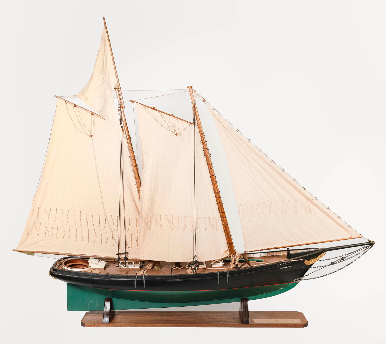 MODEL OF THE SCHOONER YACHT "AMERICA", THE FIRST AMERICA'S CUP WINNER First Half of the 20th Century: MODEL OF THE SCHOONER YACHT "AMERICA", THE FIRST AMERICA'S CUP WINNERFirst Half of the 20th CenturyNicely detailed. Rigged with sails. Displayed on brass pedestals on a wooden plinth.Height approx. 56