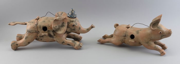 TWO CARVED WOODEN BIRDHOUSES FORMED AS A PIG AND AN ELEPHANT Contemporary Lengths 17" and 21".