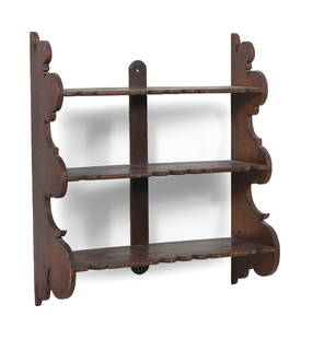 CHIPPENDALE THREE-TIER SCROLLED WALL SHELF America, 19th Century Height 28.5". Width 25.75". Depth: CHIPPENDALE THREE-TIER SCROLLED WALL SHELFAmerica, 19th CenturyProbably pine under a dark finish. Wonderfully exaggerated shaped sides and shelves.Height 28.5". Width 25.75". Depth 8.5". Provenance:Th