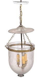 FEDERAL CLEAR GLASS AND BRASS HALL LANTERN 19th Century Bell height 13". Diameter 10.75".: FEDERAL CLEAR GLASS AND BRASS HALL LANTERN19th CenturyBlown smoke bell with grape and grape vine etching and strawberry pontil mark. Suspended from canopy by three chains that attach to peacock-shaped