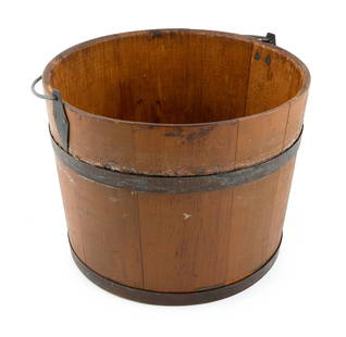 PAINTED WOODEN PAIL Possibly New Lebanon, New York, 19th Century Height to rim 9.25". Diameter 12".: PAINTED WOODEN PAILPossibly New Lebanon, New York, 19th CenturyUnder original ochre brown paint. Pine staves with tongue-and-groove joints. Iron hoops with clipped ends. Pine base plate. Handle with c