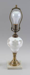 CUT OVERLAY GLASS LAMP, PROBABLY SANDWICH Mid-19th Century Total height 17".: CUT OVERLAY GLASS LAMP, PROBABLY SANDWICHMid-19th CenturyCased glass font with white cut to clear floral design. Brass collar and stem. Marble base. Electrified.Total height 17". Provenance:The Collec