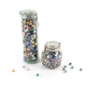 TWO GLASS CONTAINERS OF MOSTLY GLASS MARBLES Early 20th Century Container heights 6" and 13".