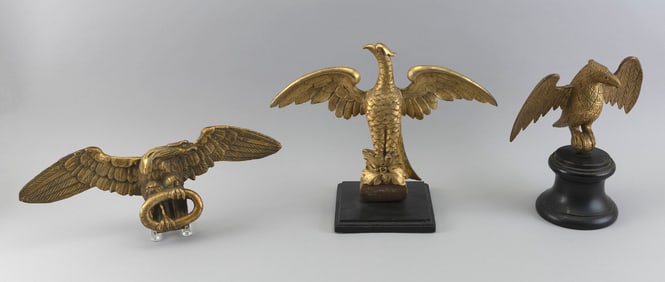 THREE CARVED WOODEN SPREAD-WING EAGLES 19th Century Heights to 13". Lengths to 16.5".