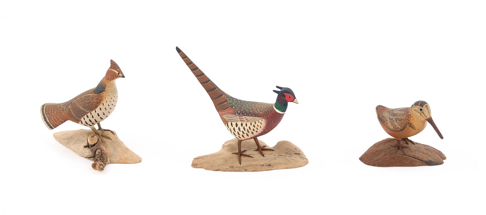 THREE HAROLD NELSON GIBBS UPLAND GAME BIRDS Barrington, Rhode Island, 1886-1970 Heights from 2" to: THREE HAROLD NELSON GIBBS UPLAND GAME BIRDSBarrington, Rhode Island, 1886-1970Circa 1960. A ruffed grouse, a woodcock and a ring-necked pheasant. All mounted on driftwood bases.Heights from 2" to 3.5"