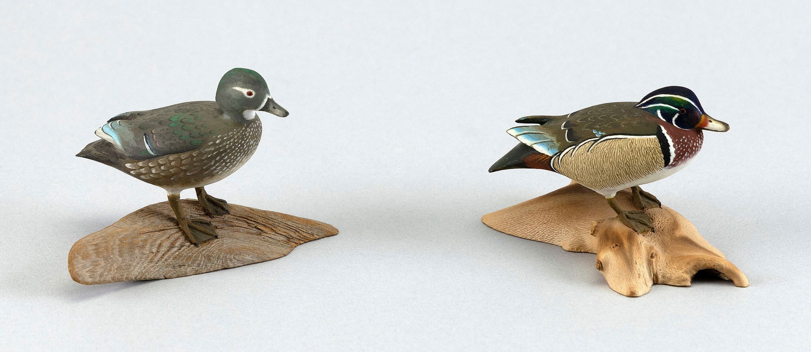 PAIR OF HAROLD NELSON GIBBS WOOD DUCKS Barrington, Rhode Island, 1886-1970 Heights 2.25" and 2".: PAIR OF HAROLD NELSON GIBBS WOOD DUCKSBarrington, Rhode Island, 1886-1970Circa 1960. Mounted on driftwood bases. Signed "HG" and "H Gibbs".Heights 2.25" and 2". Provenance:The Collection of Arthur "Bu