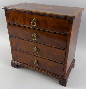 MINIATURE MAHOGANY AND FRUITWOOD VENEER CHEST 19th Century Height 10.75". Width 10.5". Depth 6".: MINIATURE MAHOGANY AND FRUITWOOD VENEER CHEST19th CenturyFour full-width drawers. Shaped bracket base.Height 10.75". Width 10.5". Depth 6".