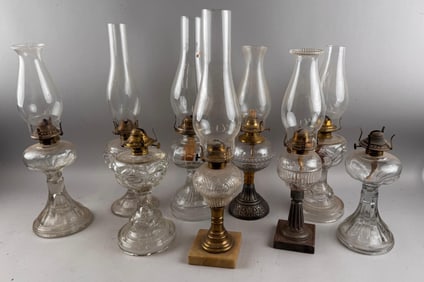 NINE CLEAR GLASS FLUID LAMPS Late 19th/Early 20th Century Heights excluding chimneys from 8" to