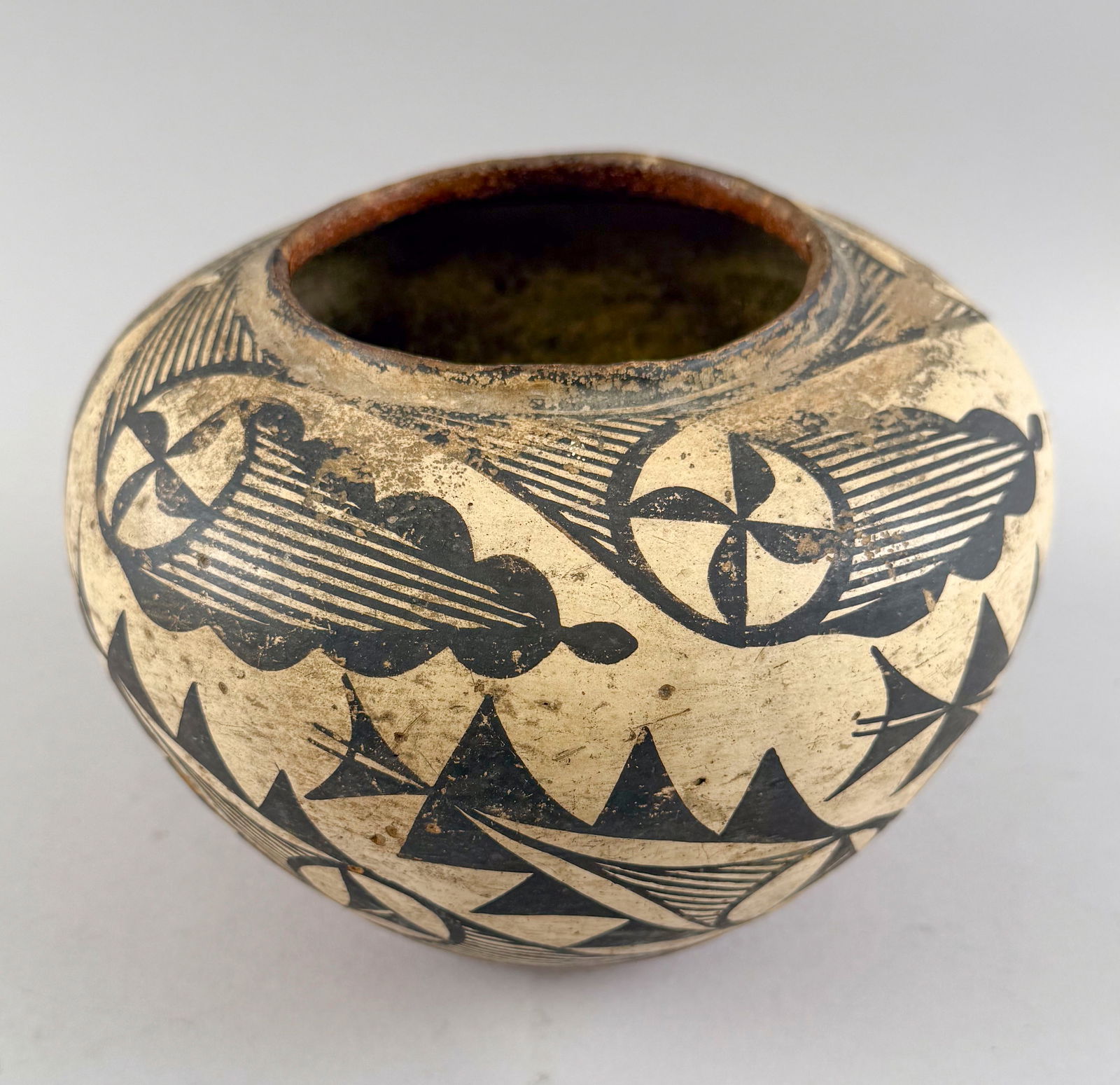NATIVE AMERICAN REDWARE POT Early 20th Century Height 6".: NATIVE AMERICAN REDWARE POTEarly 20th CenturyBlack geometric designs on a white ground.Height 6". Width 7.25".