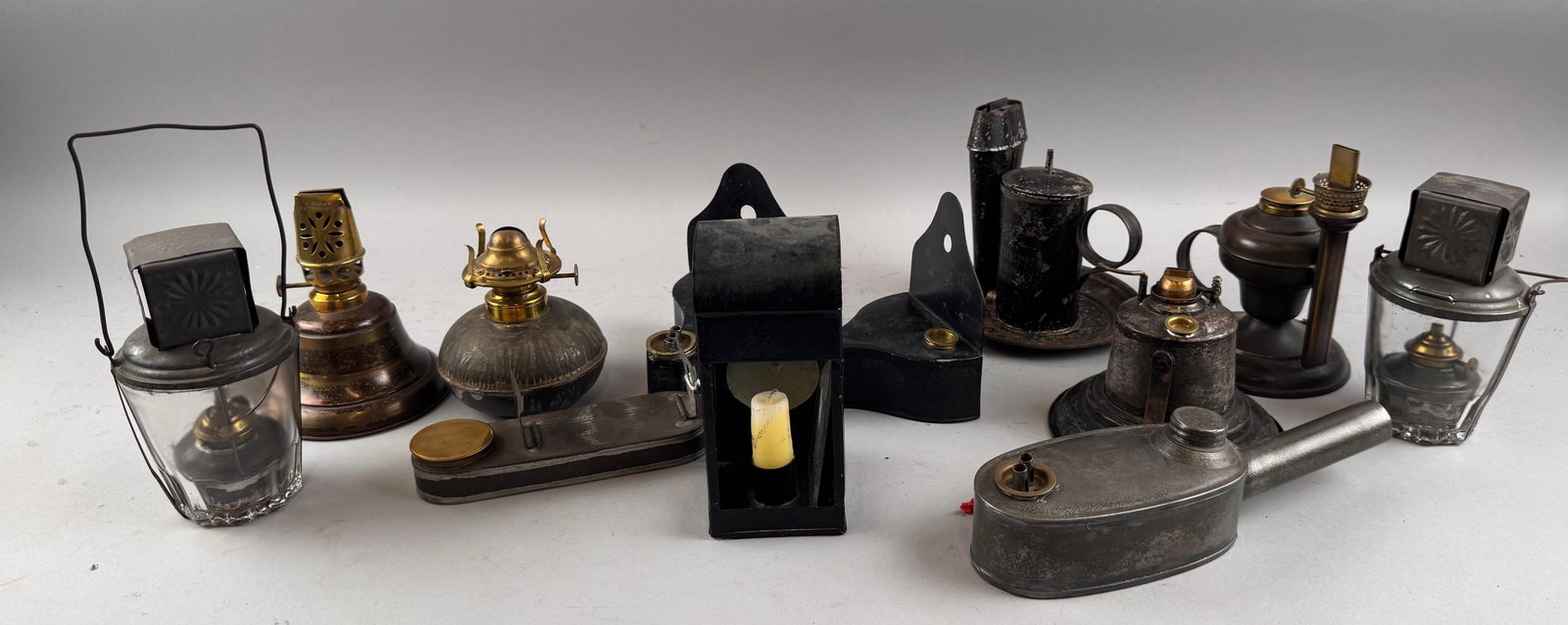 TWELVE TIN AND GLASS LAMPS 19th Century Heights from 2.25" to 6".: TWELVE TIN AND GLASS LAMPS 19th Century Varied types. Heights from 2.25" to 6". Provenance: William Dixon Collection.
