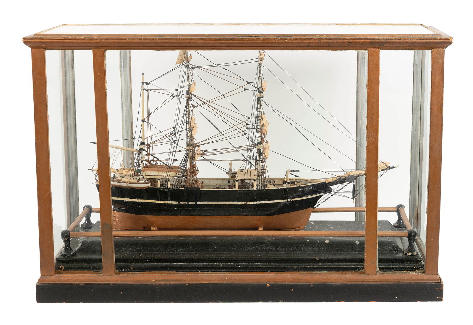 CASED MODEL OF THE WHALING BARK "WANDERER" OF NEW BEDFORD Circa 1895 Case height 24". Length 37.5".: CASED MODEL OF THE WHALING BARK "WANDERER" OF NEW BEDFORDCirca 1895Detailed with deckworks, whaleboats on davits, furled sails, etc. Displayed on cradles within a glass and wood case.Case height 24".