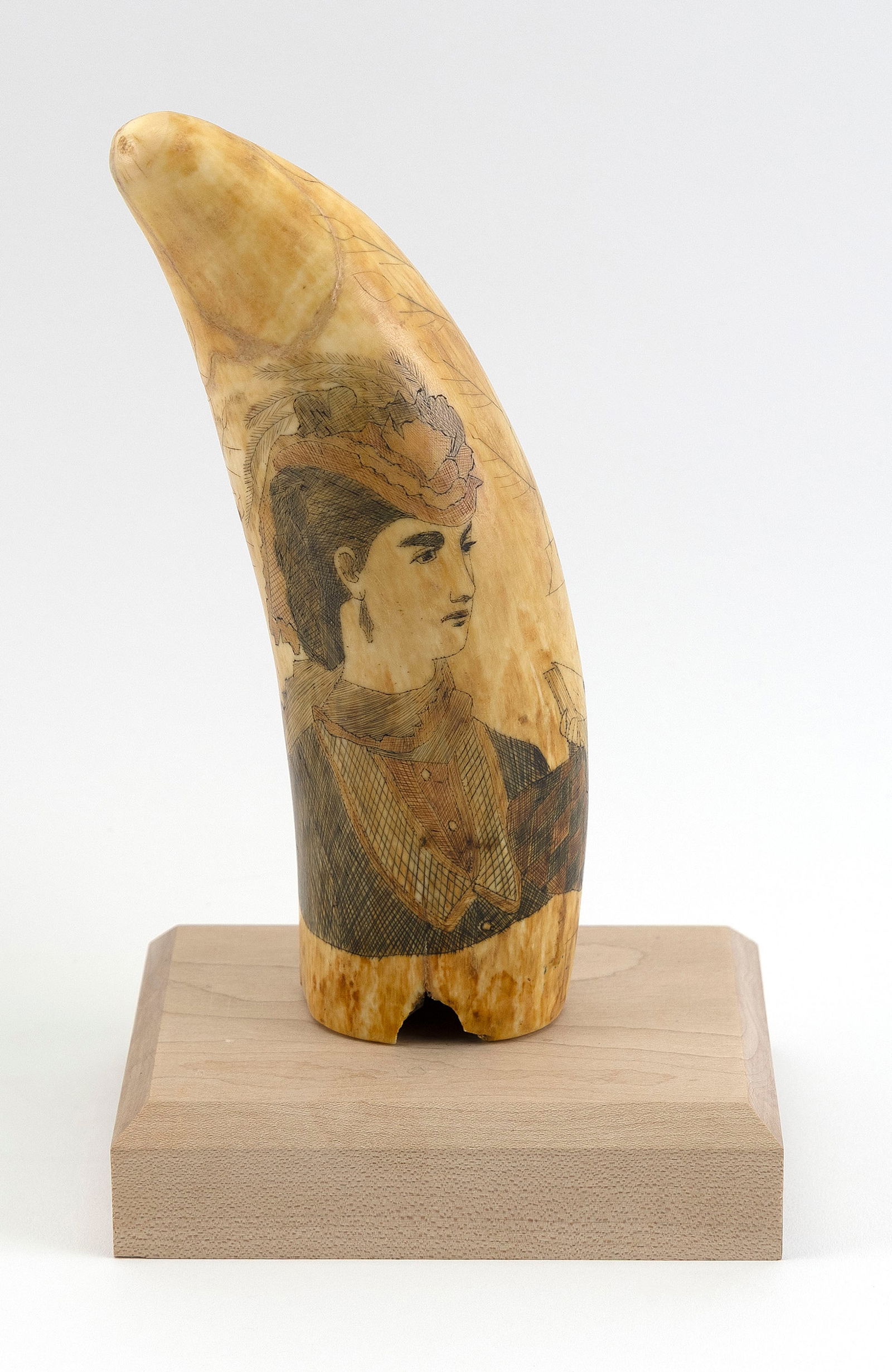 POLYCHROME SCRIMSHAW WHALE'S TOOTH WITH PORTRAITS OF WOMEN 19th Century Length 7.25".: POLYCHROME SCRIMSHAW WHALE'S TOOTH WITH PORTRAITS OF WOMEN19th CenturyObverse depicts a young woman wearing a red and black checked dress seated in a Windsor chair. Reverse with a bust portrait of a w