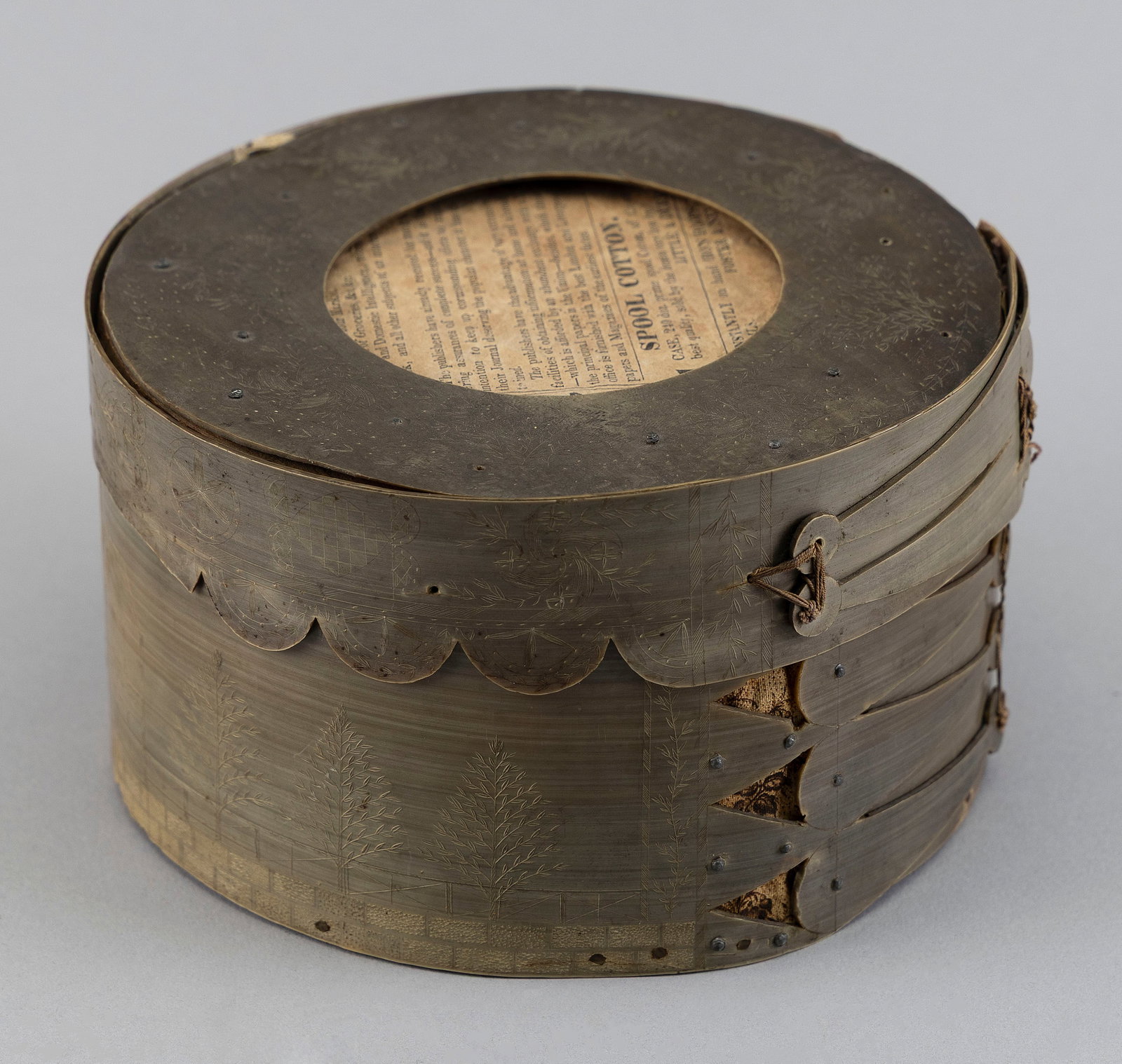 SCRIMSHAW BALEEN DITTY BOX Second Quarter of the 19th Century Height 3.25". Diameter 5.75".: SCRIMSHAW BALEEN DITTY BOX Second Quarter of the 19th Century Top of lid with floral designs around a circular aperture (once set with a mirror that is now missing). Scalloped lip with geometric and f
