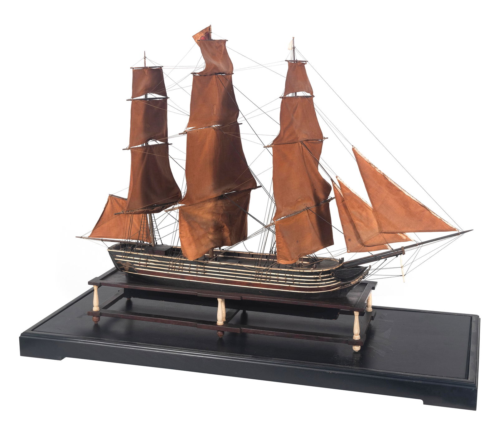 CASED SAILOR-MADE MODEL OF A PACKET OR MERCHANT SHIP 19th Century Case height 34.75". Length 45".: CASED SAILOR-MADE MODEL OF A PACKET OR MERCHANT SHIP19th CenturySeen in full sail, fully rigged with fabric sails and flying the house flag of Dunham & Diamon, New York City merchants in the 1840s. Wo