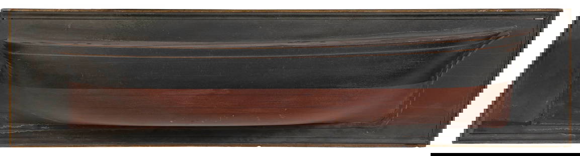 MOUNTED BUILDER'S HALF HULL MODEL OF A LARGE SAILING VESSEL 19th Century Backboard 15.5" x 62".: MOUNTED BUILDER'S HALF HULL MODEL OF A LARGE SAILING VESSEL19th CenturyBuilt up in 12 lifts. Natural wood finish, the hull painted black above the waterline. Applied prow, skeg and painted trailboards