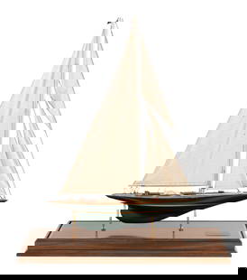 CASED MODEL OF THE AMERICA'S CUP YACHT "SHAMROCK V" 20th Century Case height 39". Length 33". Width: CASED MODEL OF THE AMERICA'S CUP YACHT "SHAMROCK V"20th CenturyOwned by Sir Thomas Lipton. Planked mahogany deck. Linen sails. Displayed on brass pedestals within a brass-trimmed glass case with woode