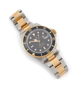 ROLEX STAINLESS STEEL AND 18KT YELLOW GOLD SUBMARINER Circa 1991