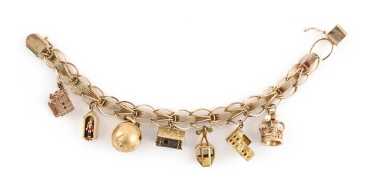 14KT YELLOW GOLD CHARM BRACELET WITH 14KT AND 18KT YELLOW GOLD CHARMS Approx. 32.5 total dwt.