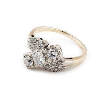 14KT WHITE AND YELLOW GOLD AND DIAMOND RING Approx. 2.8 total dwt.: 14KT WHITE AND YELLOW GOLD AND DIAMOND RINGBypass design. The center with one old mine-cut and two round diamonds and the sides with 12 small round-cut diamonds, approx. 0.60 ctw. Stamped. Size 6.Appr