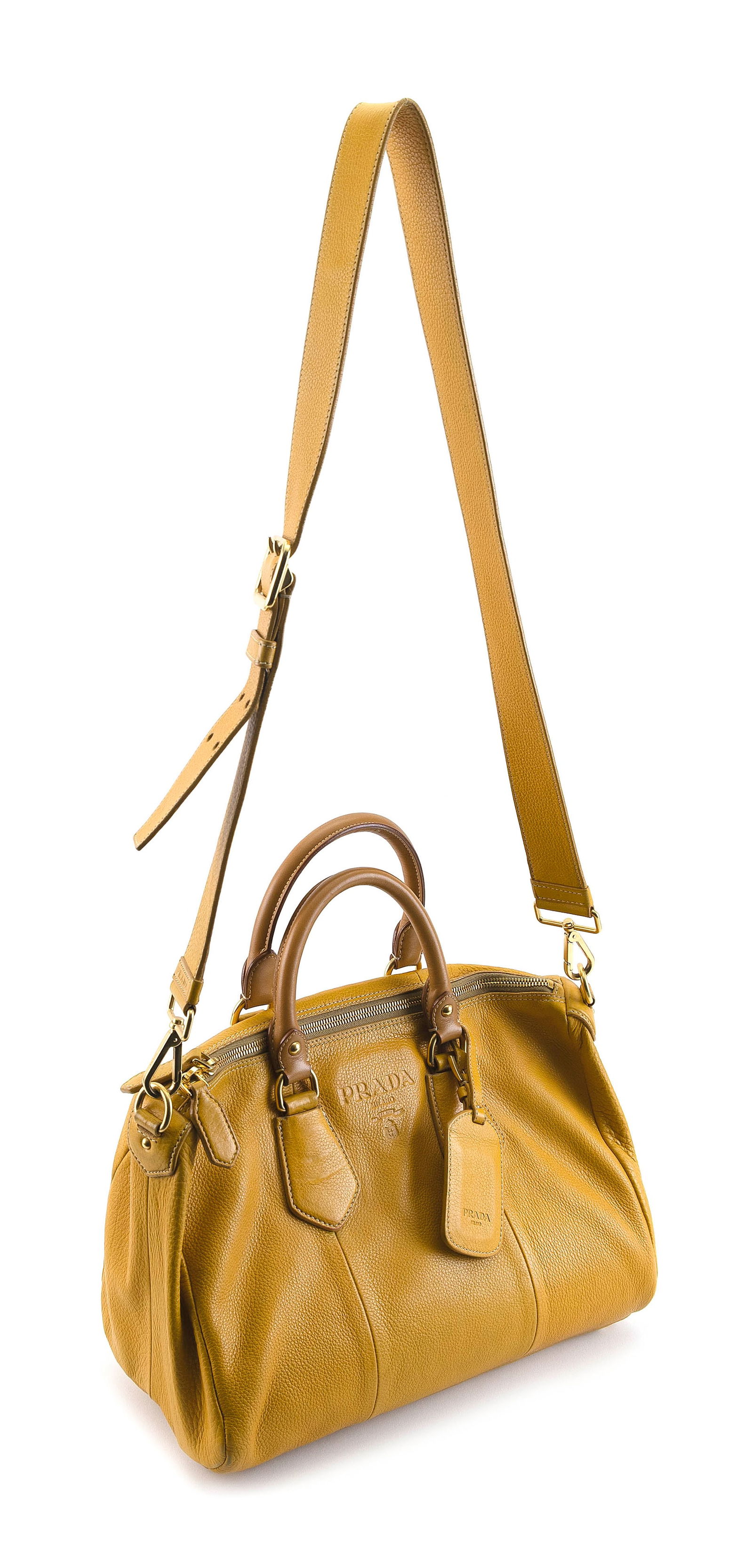 PRADA VITELLO DAINO DOME CONVERTIBLE SATCHEL Height 11". Width 13.5". Depth 6.5".: PRADA VITELLO DAINO DOME CONVERTIBLE SATCHELIn mustard. With gold tone hardware and rolled handles.Height 11". Width 13.5". Depth 6.5". Provenance:The Collection of Arun and Barbara Singh.The procee
