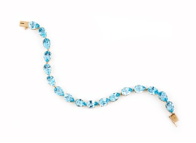 14KT YELLOW GOLD AND BLUE TOPAZ BRACELET Approx. 8.7 total dwt.