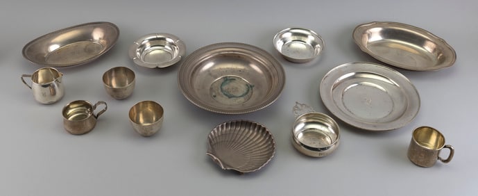 THIRTEEN PIECES OF STERLING SILVER Early to Mid-20th Century Approx. 64.6 total troy oz.