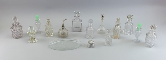 COLLECTION OF CLEAR GLASS PERFUME AND COLOGNE BOTTLES Early 20th Century Heights from 1.5" to 6.25".