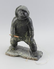 PITSIULAK OSHUTSIAQ CARVED SOAPSTONE FIGURE OF A FISHERMAN Kinngait (Cape Dorset), Nunavut, 1970-