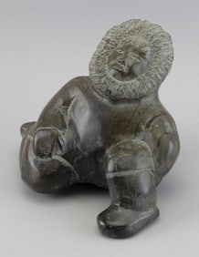 MANOMEE SHAQU CARVED SOAPSTONE FIGURE OF A KNEELING MAN Kinngait (Cape Dorset), Nunavut, 1917-