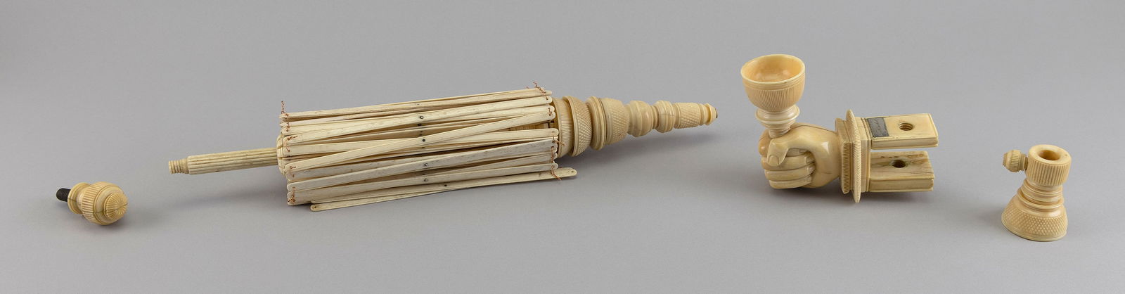 WHALEBONE AND WHALE IVORY SWIFT 19th Century Height approx. 18".: WHALEBONE AND WHALE IVORY SWIFT19th CenturySpire finial with crosshatch carving. Clamp carved as a fist clenching the yarn cup.Height approx. 18".